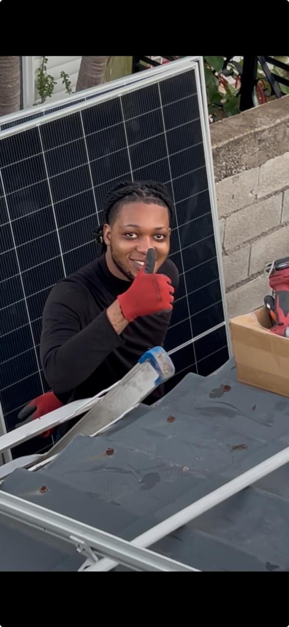 A Something Cool technician installing a solar panel